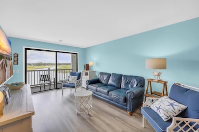 Living area with wood finished floors and a water view