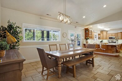 Dining area with french doors and lofted ceiling
