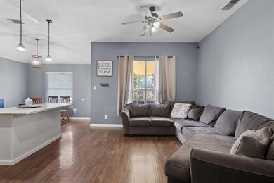 Living room with dark wood-type flooring, a ceili