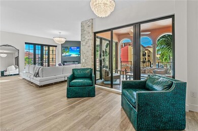 Living area featuring an inviting chandelier and w