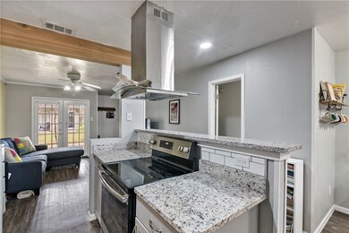 Kitchen with visible vents, stainless steel range