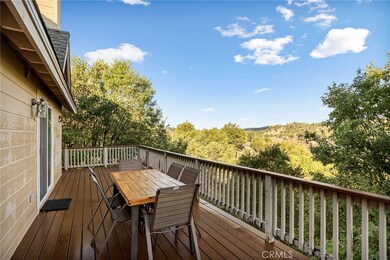 Expansive deck with room for outdoor dining, showcasing sweeping treetop views and plenty of sunshine for gatherings.