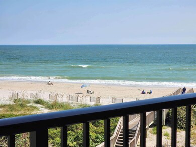 Water view featuring a view of the beach and fence
