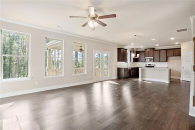 Unfurnished living room featuring ceiling fan, sin