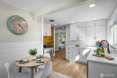 Kitchen with eating space, newer cabinets and quartz counters.