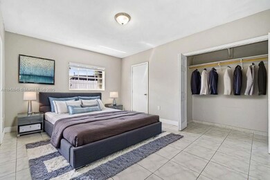 Master bedroom featuring ample closet space and a large window for natural light