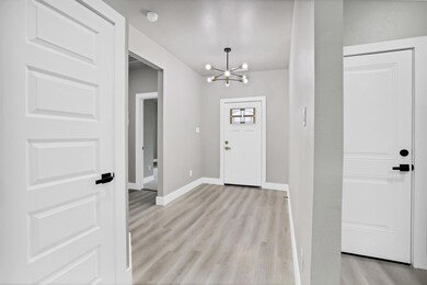 Entryway with light wood-type flooring and an invi