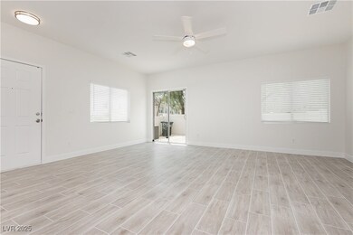 Unfurnished room with a ceiling fan and light wood