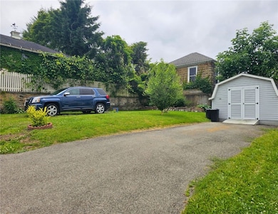 Drive way with shed and green area.