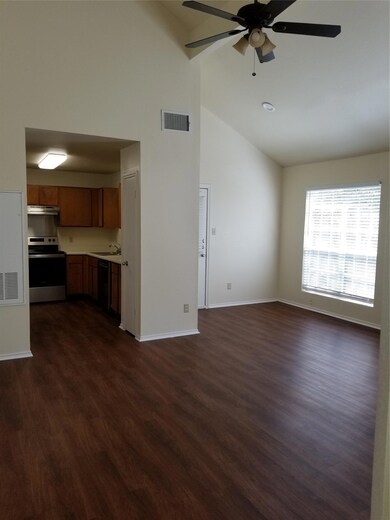 Unfurnished living room featuring high vaulted ce