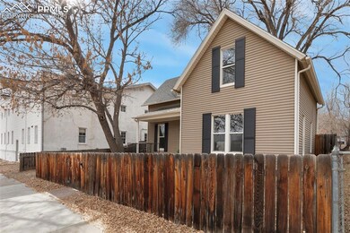 Fully fenced front yard with covered porch.