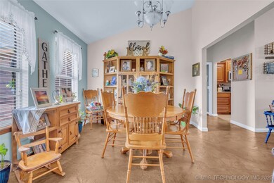 Dining area with vaulted ceiling, a chandelier, fi