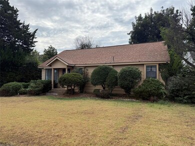 View of front facade with a front yard and roof with shingles