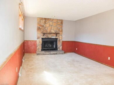 Family room with wood burning fireplace.