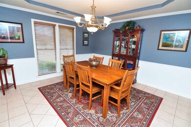 The dining room showcases tile floor, trayed ceili