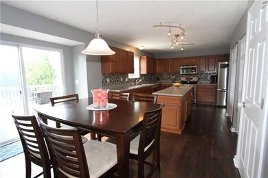 The eat in kitchen with beautiful hardwood floors 