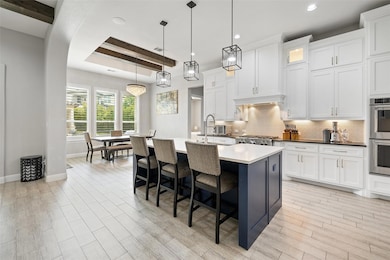 Kitchen with tasteful backsplash, stainless steel