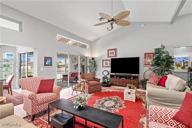 Living room with ceiling fan, light tile patterned