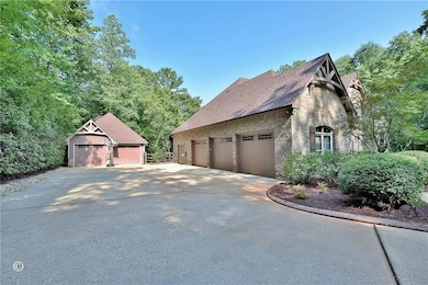View of property exterior with brick siding and a shingled roof