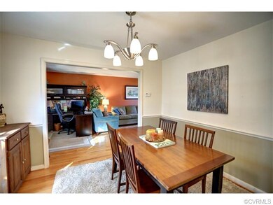 Dining room with chair rail, fresh paint, wood flo
