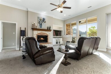 Spacious living room with custom built-in entertainment center with light feature, crown molding and carpet replaced in Fall 2020.