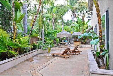 Backyard oasis with custom hardscape, mature palms