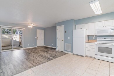 Kitchen featuring white appliances, white cabinets