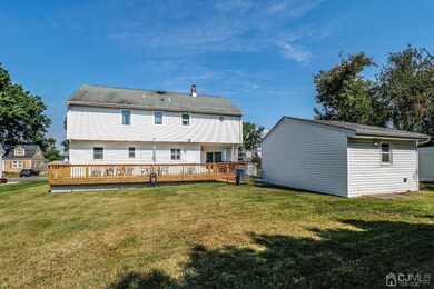 Exterior view of this expanded home with park like yard and oversized detached garage.