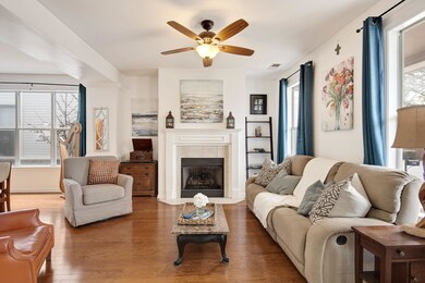 Living room with visible vents, wood finished floo