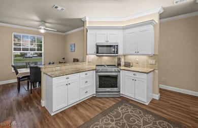 Kitchen with light stone countertops, appliances w