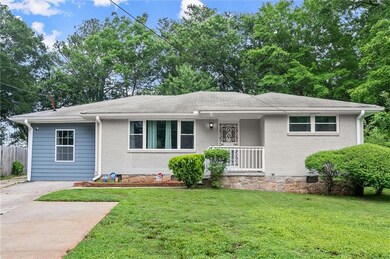 View of front of property with brick siding, covered porch, a shingled roof, and concrete driveway
