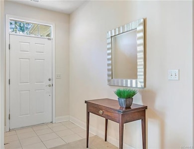 Tile floor.  The solid door opens to a full glass 