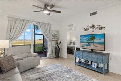 Living area with crown molding, ceiling fan, and light tile patterned flooring