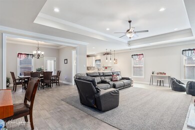 Living area featuring light wood-style floors, a t