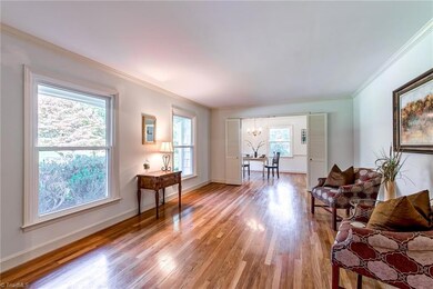 The Living room is light and bright with gleaming hardwoods continuing to Dining Room