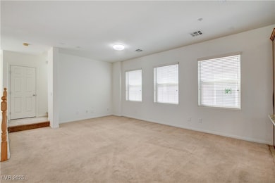 Living room looks over dining room and kitchen