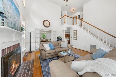 Living area featuring visible vents, stairs, wood