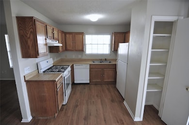Kitchen featuring white appliances, under cabinet