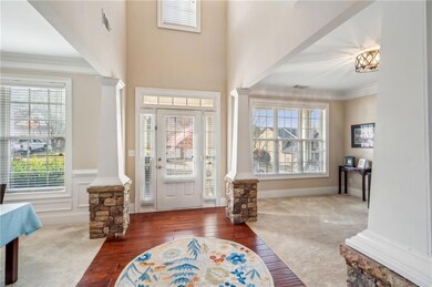 Entrance foyer featuring carpet flooring, a wealth