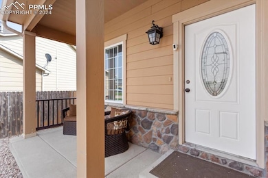 View of exterior entry with a porch