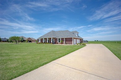 View of front of home with an attached garage, con