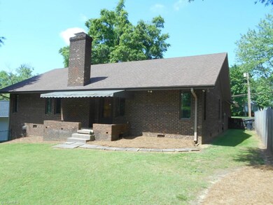Back of home has an awning covering the porch.