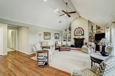 Fantastic living room 20' X 30 ' with hardwoods, vaulted ceiling, fireplace and floor to ceiling windows/door leading to the beaustiful patio.