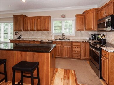 Awesome Kitchen is an entertainer's delight ~ Rich cabinetry, granite counter tops with composite sink, stainless appliances including refrigerator & 'quiet' dishwasher.