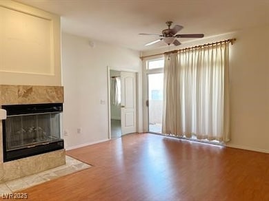 Unfurnished living room featuring a ceiling fan, w