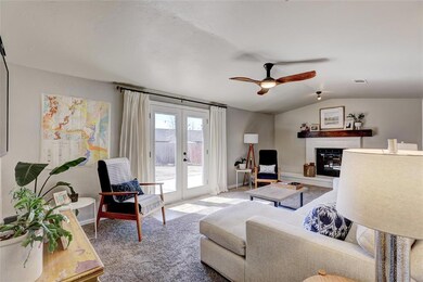 Carpeted living room featuring french doors, ceili