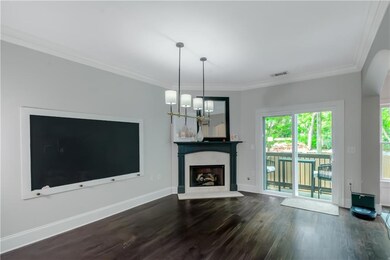 Unfurnished living room with dark wood-style flooring, plenty of natural light, crown molding, baseboards, and a chandelier