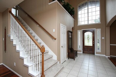 Stunning two story entry features leaded glass front door and tile floors