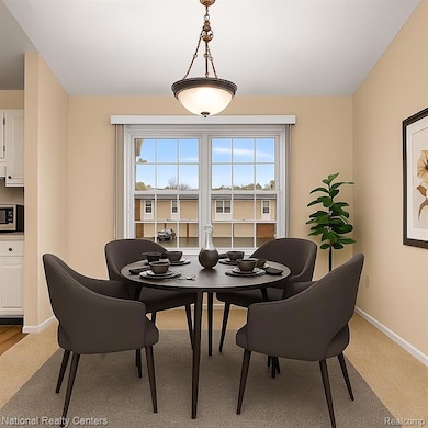 Dining area with healthy amount of natural light and light carpet