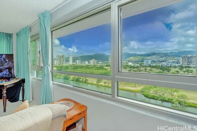 Living room views of the Ala Wai Canal and Mountai